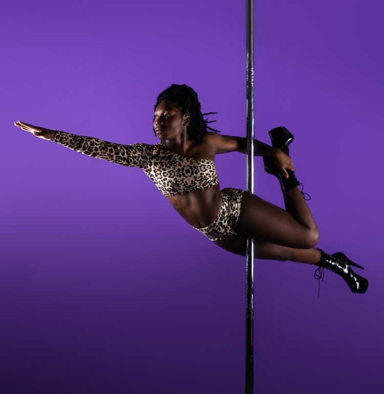 Instructor Chaniqua holding a pose during a class at The Pole Hub